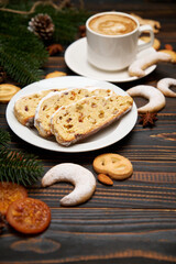 Sliced Traditional Christmas stollen cake with marzipan and dried fruit with New Year decorations