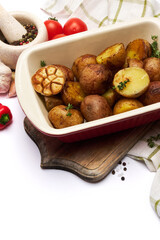Baked potato in baking dish pot isolated on white background