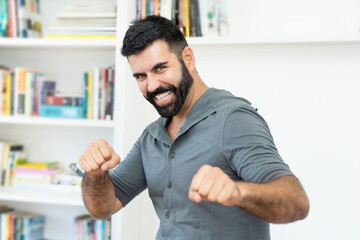 Cheerful hispanic mature adult man with beard