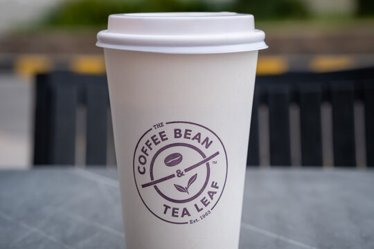 Close up of a Purple The Coffee Bean and Tea Leaf logo on a paper cup