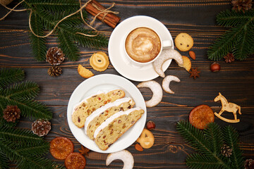 Sliced Traditional Christmas stollen cake with marzipan and dried fruit with New Year decorations