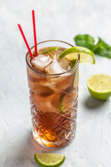 Cuba Libre or long island iced tea cocktail with strong drinks, cola, lime and ice in glass, Alcoholic or non-alcoholic cold longdrink or lemonade