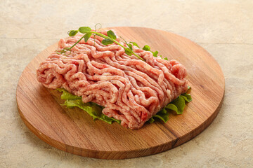 Raw minced pork meat over board