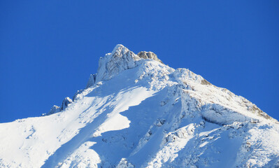 Obraz premium Winter ambience and beautiful idyllic atmosphere on the steep alpine rocky peak Stooss or Stoss (2112 m.a.s.l.) and the mountain Alpstein - Appenzell Alps massif - Switzerland (Schweiz)