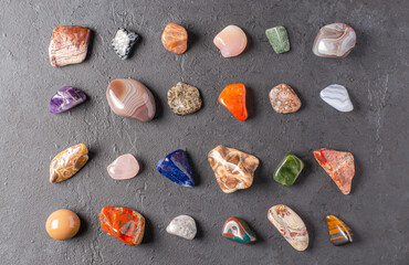 Mineral stones on a black concrete background. The concept of using minerals in astrology and alternative or complementary medicine.