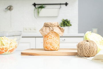 The pot with sauerkraut in the kitchen. Light background. Horizontal view. Canned food.