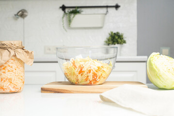The preparation process fermentation preservation sauerkraut in the kitchen. Light background. Horizontal view. Canned food.