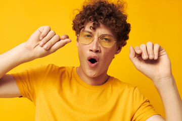 cute red-haired guy wearing stylish glasses yellow t-shirt posing monochrome shot
