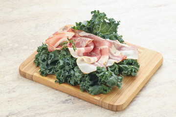 Raw pork bacon over board