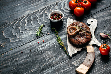 grilled fresh cross cut veal shank for making Osso Buco on meat cleaver. Long banner format. top view