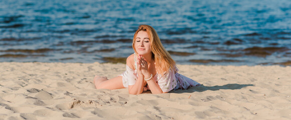 Woman in pink romantic soft long dress at beach, sunny warm day. Relax and freedom concept 