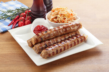 Grilled sausages with cabbage and sauce
