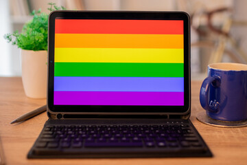 Galicia, Spain - February 11, 2022: laptop on desk with lgbt pride flag