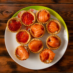 edible baskets with red caviar and pieces of salmon.