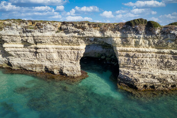 Seacoast of Otranto, Puglia, Salento, Italy. Turquoise sea, clear blue sky, rocks, sun, Tourist Apulia, Aerial View Sea