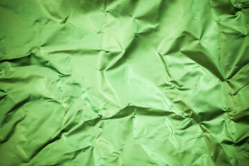 Crumpled green aluminum foil background.