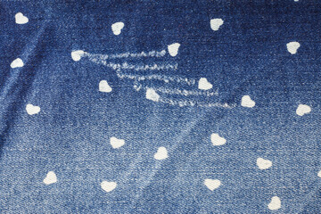 Small heart blue jeans texture background.