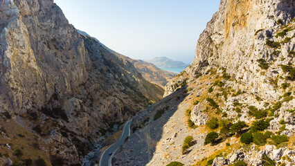 Empty rural road through the beautiful gorge of Kourtaliotikos in Crete Island in Greece.
