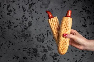 Set of French hot dogs in woman's hand, fast food and junk food concept, Street food, Long banner...