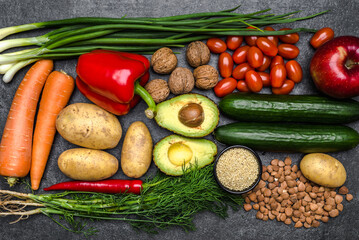 Healthy food background. Healthy vegetarian food. Vegetables and fruits on black stone. Clean vegetarian eating concept.