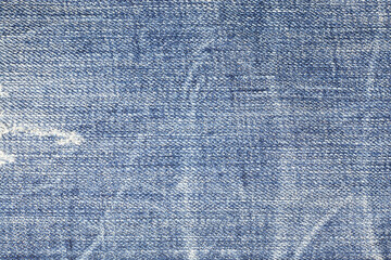 Torn denim jeans texture.