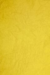 Crumpled vintage yellow paper textured obsolete background.