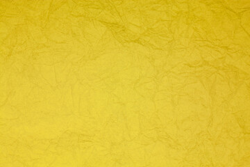 Crumpled vintage yellow paper textured obsolete background.