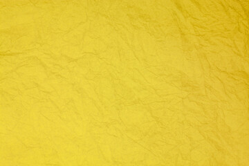 Crumpled vintage yellow paper textured obsolete background.