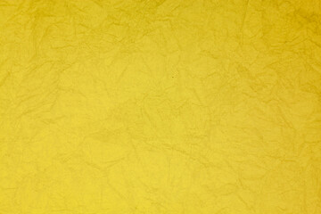 Crumpled vintage yellow paper textured obsolete background.