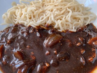 Korean noodle with gravy black sauce in the white dish. Selective focus on object. Jajangmyeon is delicious korean noodle. Korean noodle concept. Close up.
