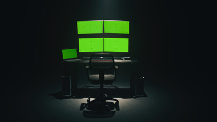 Computer monitors with chromakey green screens placed on table in dark ambient room of hacker base