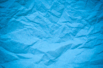 Blue crumpled paper background.