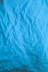 Blue crumpled paper background.