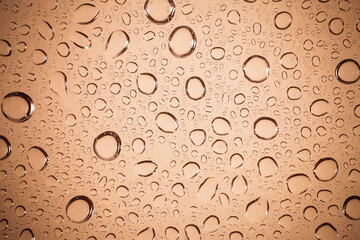 water drops on Brown glass background.