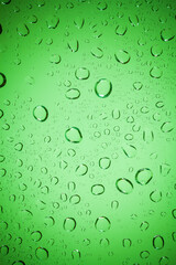 water drops on Green glass background.
