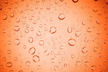 Bubble water on red glass background.