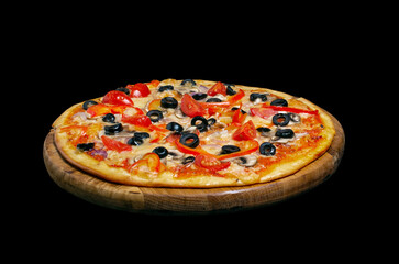Vegetarian pizza, on a wooden kitchen board. Isolated on black background