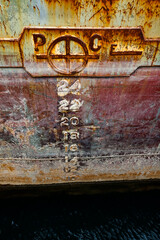 Aged rusted ship side. Barge in cargo terminal. Close up photo