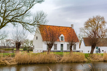 Fototapeta na wymiar A rustic house at the bank of Damme canal in Belgium