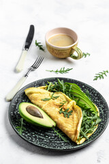 Omelet and Salad with green vegetables avocado and arugula, Delicious vegan, vegetarian breakfast