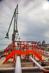 Mangystau, Kazakhstan: Bautino bay. Oil loading terminal on Caspian sea. Loading arm and extinguishing system. Orange stair.
