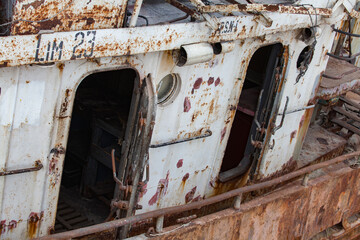 Old rusted ship on Caspian Sea, Bautino bay, ship-repairing yard. Close up of doors and portholes. Mangystau, Kazakhstan.