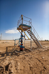 Oil well in desert. Maintenance platform. Blue sky. Zhanaozen, Kazakhstan.