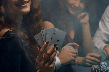 woman poker player showing a combination of four aces
