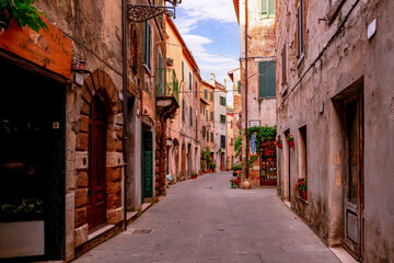 Narrow street with historic medieval houses in Pitigliano Tuscany