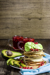 Pancakes with avocado ice cream. Avocado. Lingonberry juice.