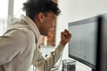 African american trader saying yes and feeling happy after stocks jumped