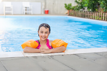 little girl having fun in the pool