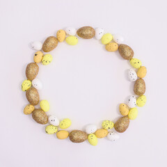 Creative frame copy space on white background with orange, yellow and orange eggs for Easter. Flat lay concept