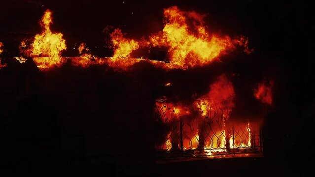house fire. the building is on fire burning a danger smoke sparks. fire safety natural disaster concept. fire in factory the building at night close-up